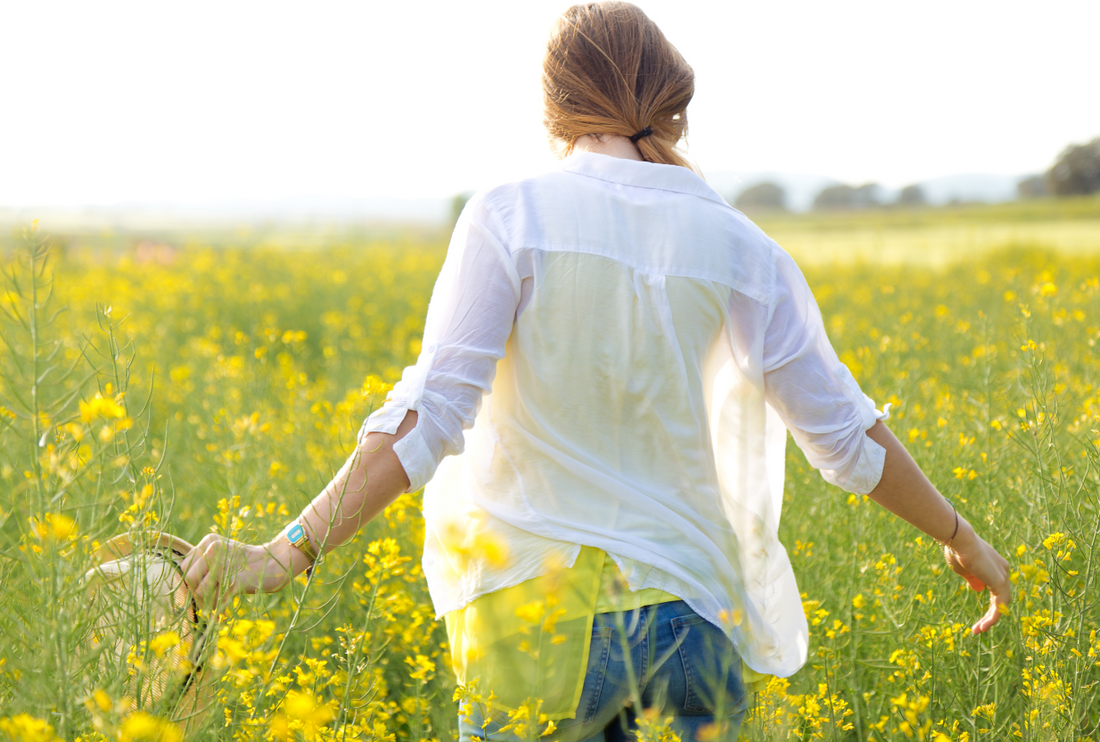 young woman enjoying summer in a field