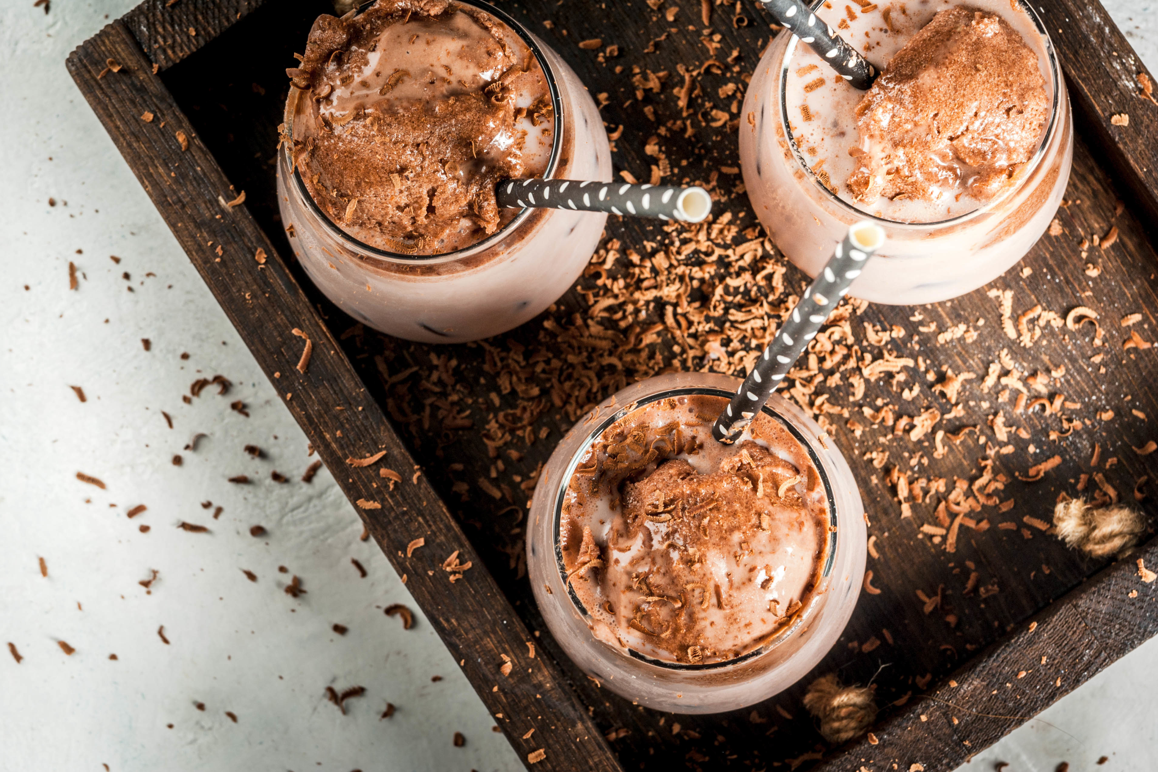 three cups of iced mocha in wooden crate