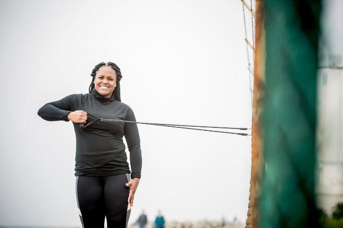 woman pulling a resistance band