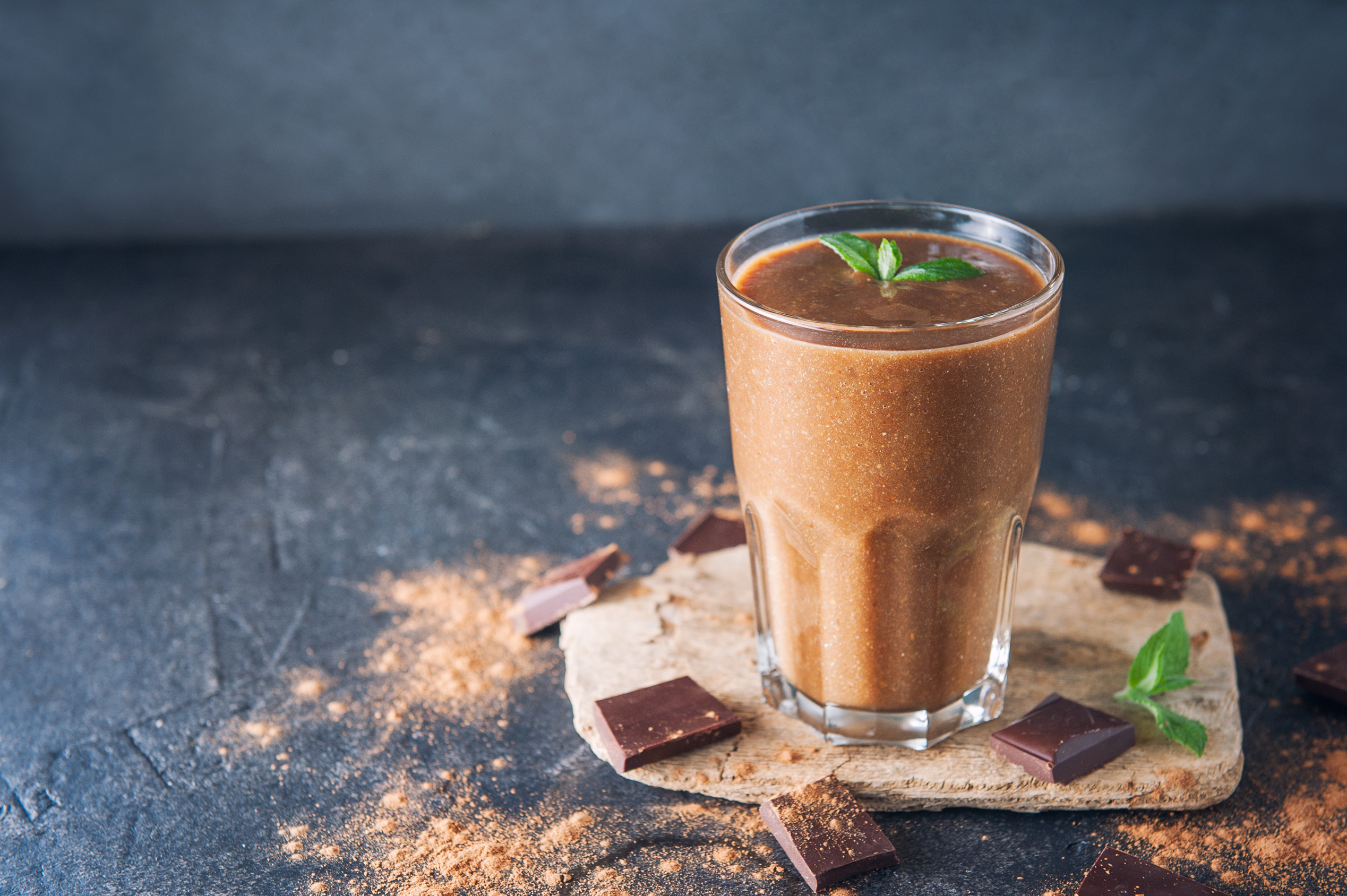 a glass of moose track shake, chunks of chocolate and sprinkled powder on the surface