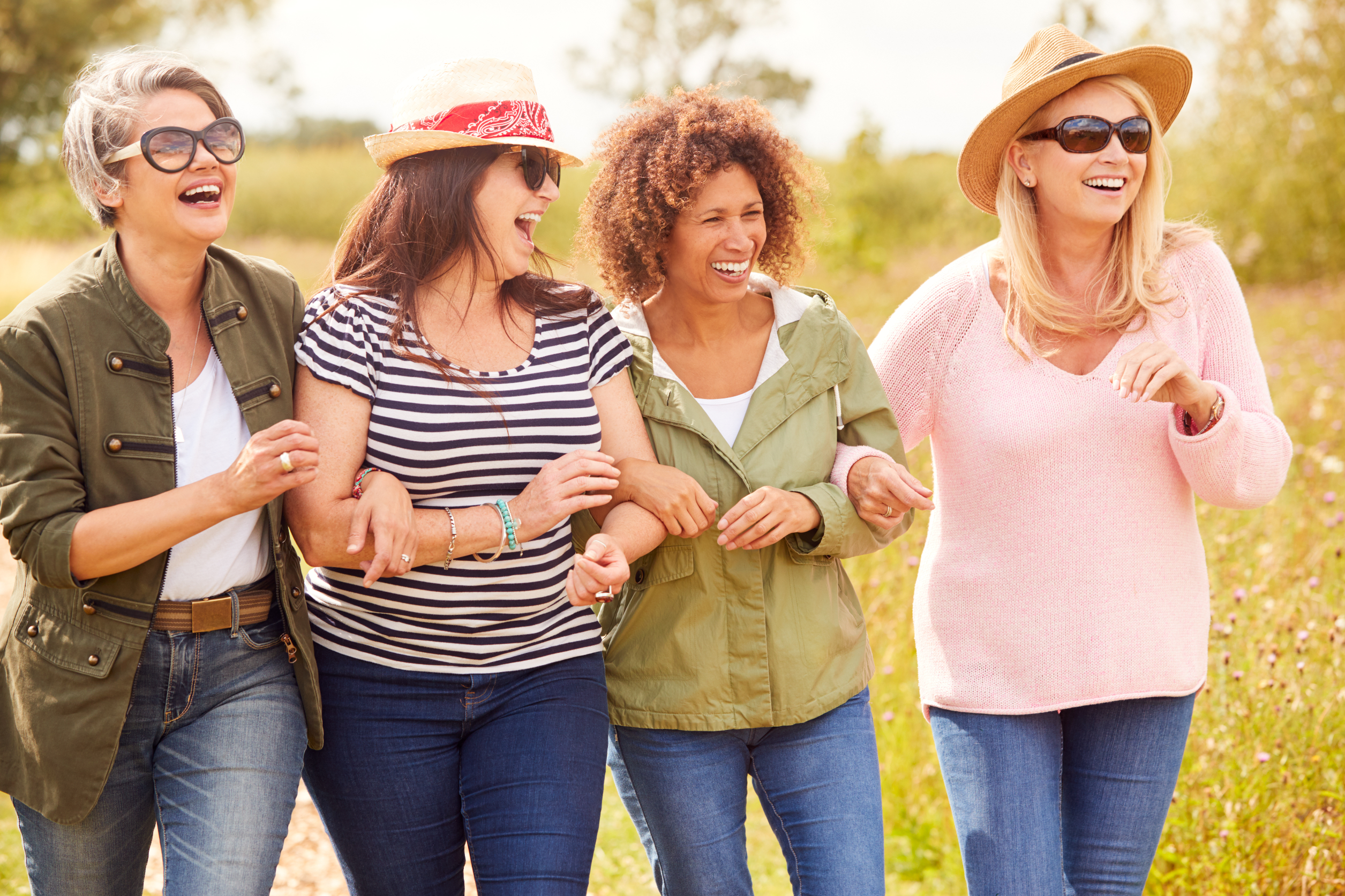 four woman smiling together