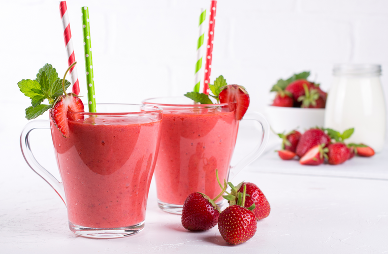 fresh strawberries and two glasses of strawberry shake