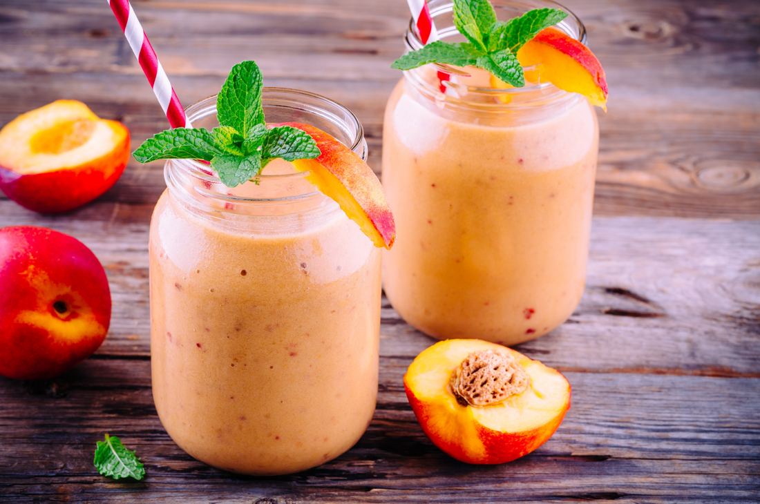 peach smoothies in a mason jar with mint on wooden rustic background