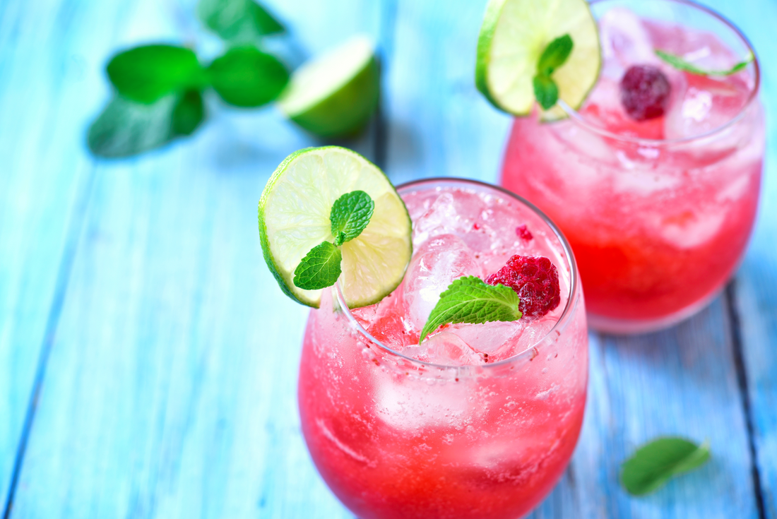 raspberry hibiscus refresher with mint leaves and lime