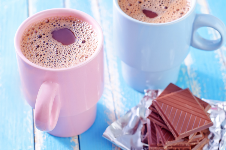 hot chocolate in pastel mugs with chocolate bars