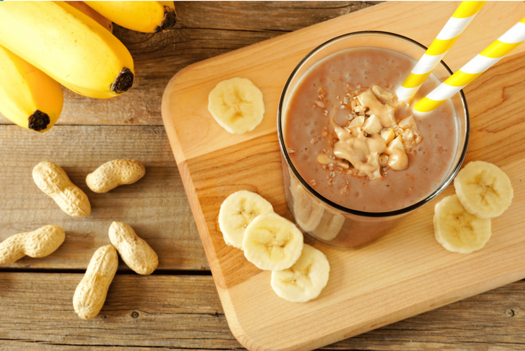 reese's shake and banana slices on a wooden board