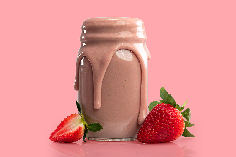 strawberry shake with fresh strawberries and pink background