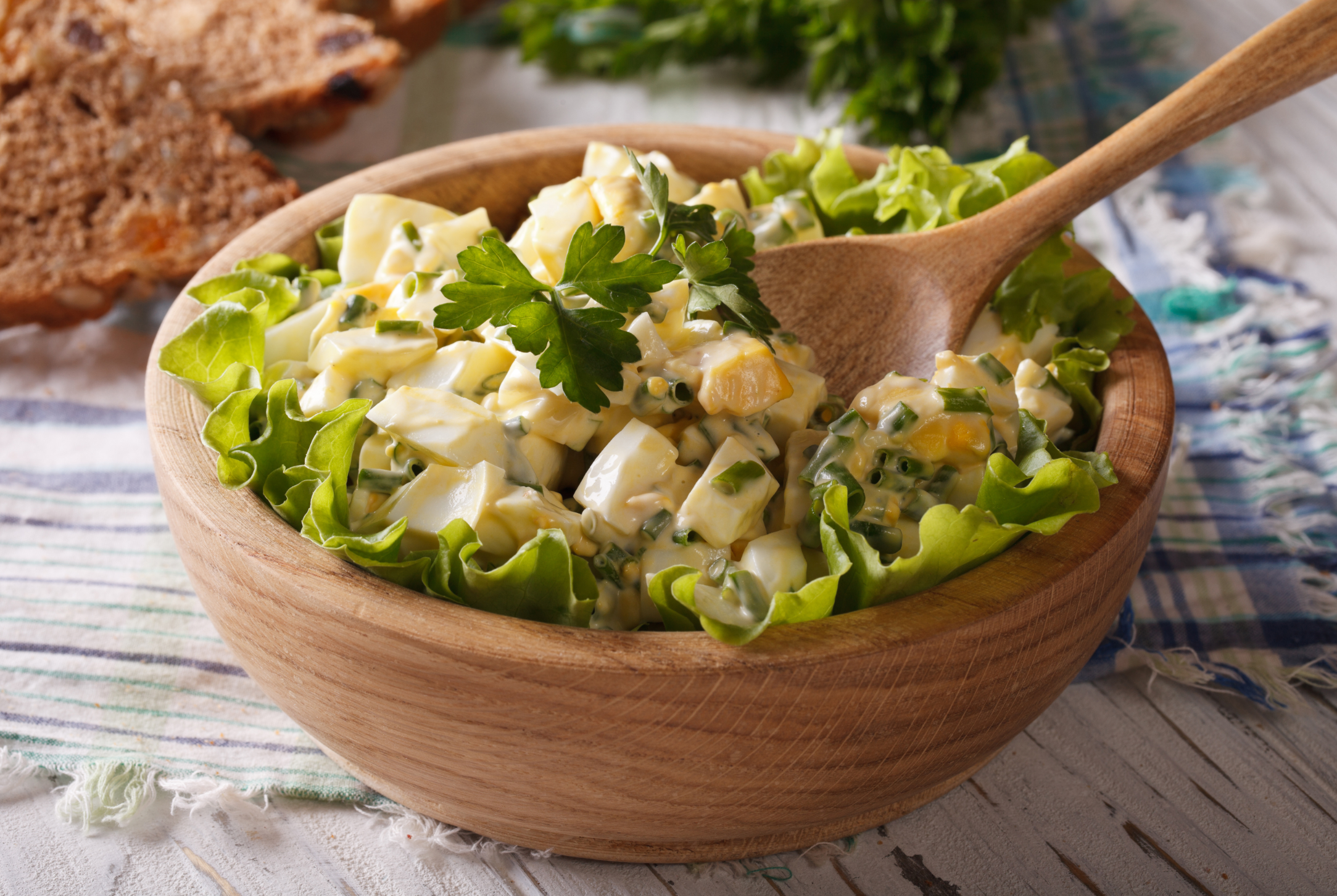 egg salad in a wooden bowl, close-up, rustic style