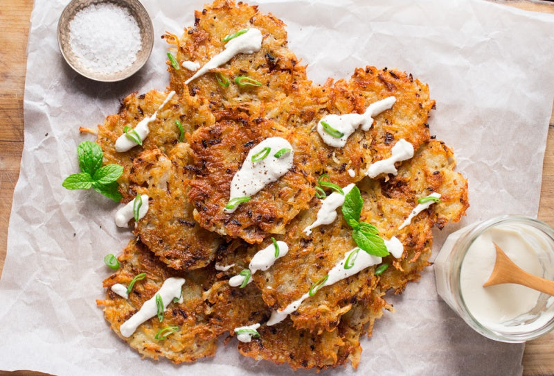 vegan latkes with sour cream on a white sheet