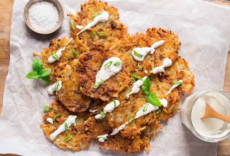 vegan latkes with sour cream on a white sheet