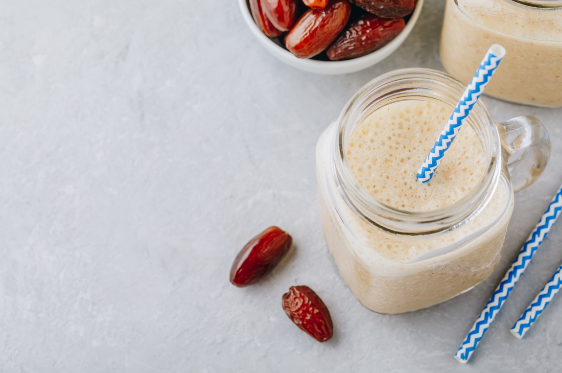 overhead view of salted caramel shake with blue straw on a mason jar