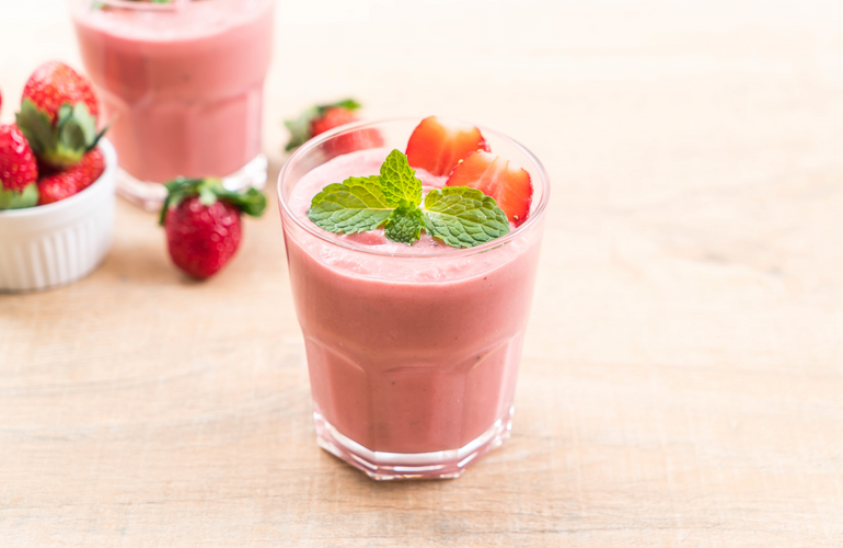 avocado strawberry smoothie in glasses