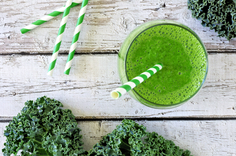 overhead view of tropical green smoothie on a wooden table 