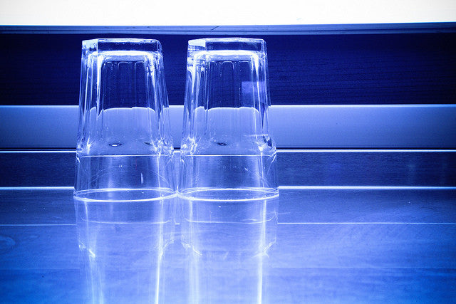 two drinking glasses against a blue background