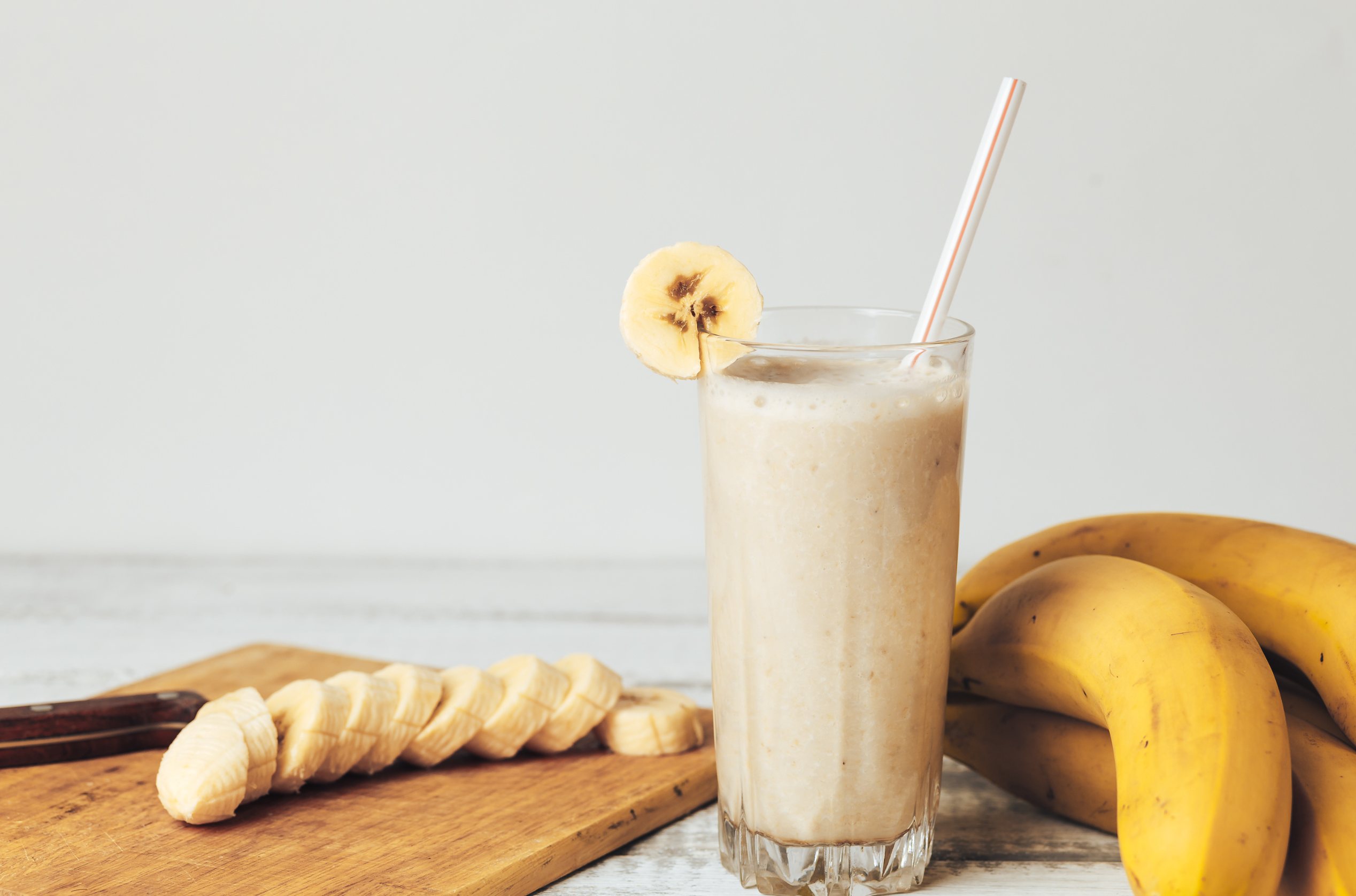 coconut vanilla smoothie with fresh bananas in glass