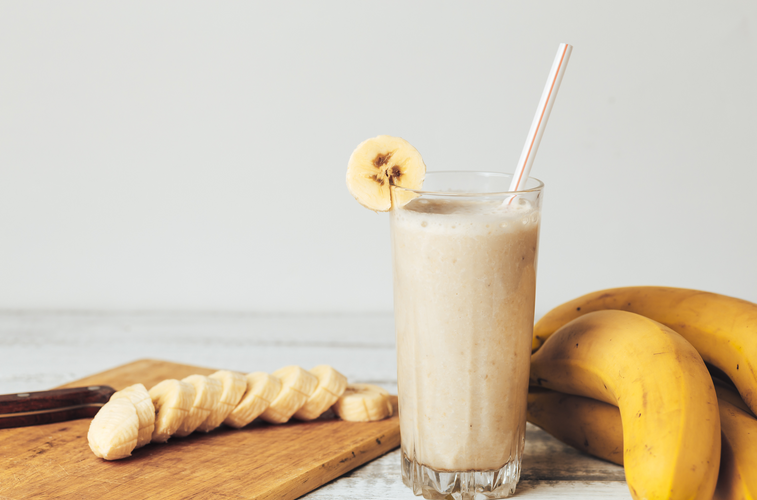 coconut vanilla smoothie with fresh bananas in glass