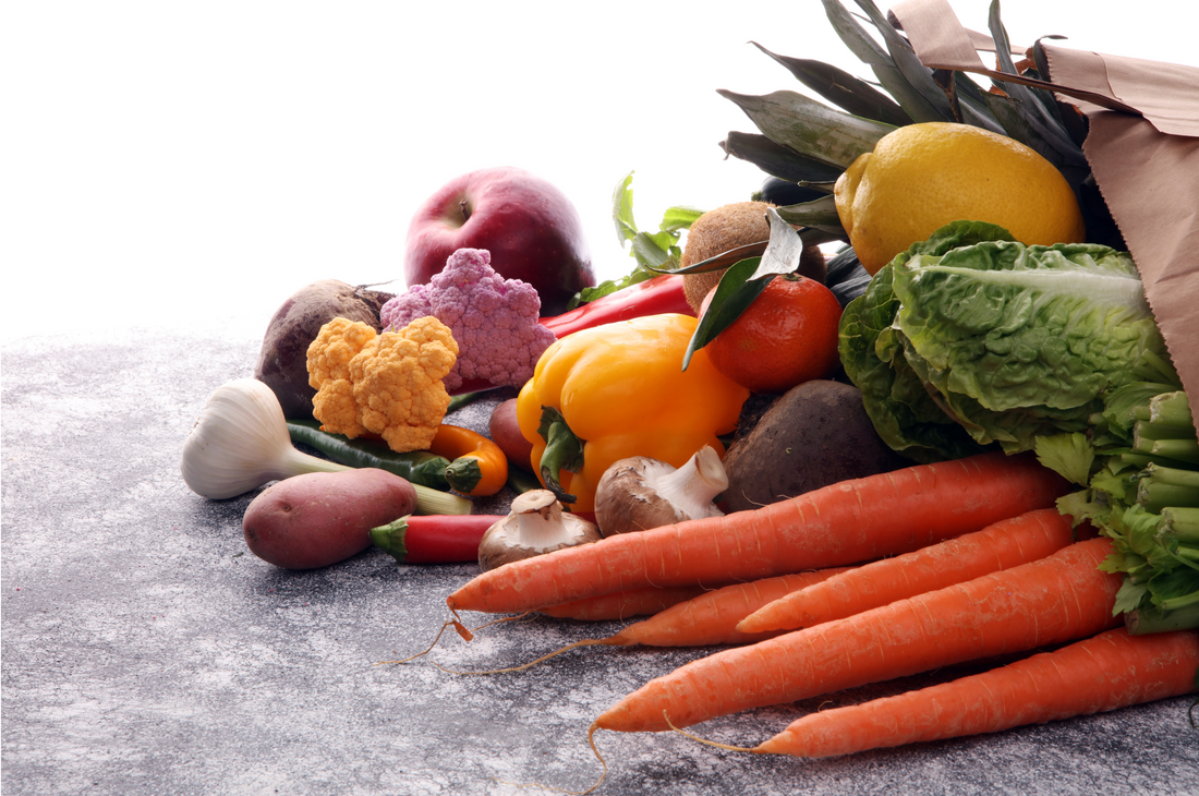 stack of fresh vegetables including carrots, pumpkins and more