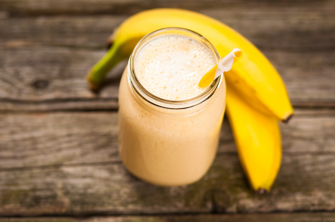 very vanilla shake and fresh bananas on a wooden table