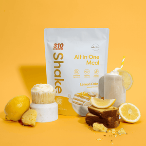 310 Lemon Cake surrounded with a glass of shake, cupcake and lemons.