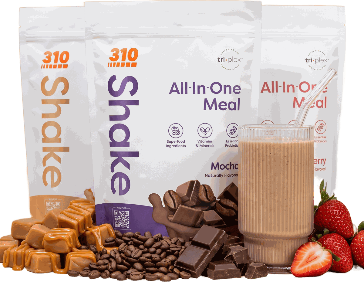 Three 310 All-In-One Meal shake pouches and a shake, with caramel, coffee, chocolate and strawberries