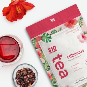 310 Hibiscus Tea pack with a cup of tea, loose hibiscus leaves and a hibiscus flower.