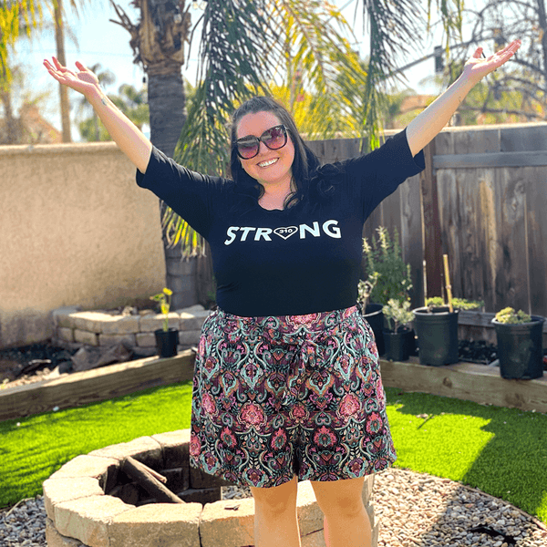 a woman in the backyard wearing strong shirt
