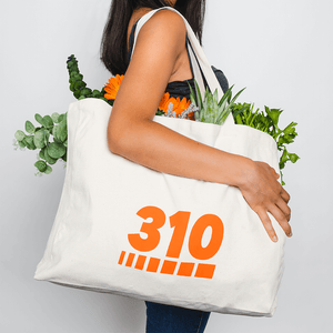 woman wearing the white canvas tote bag with flowers inside