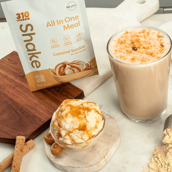 caramel sundae with a glass of shake and a bowl of ice cream drizzled in caramel syrup.