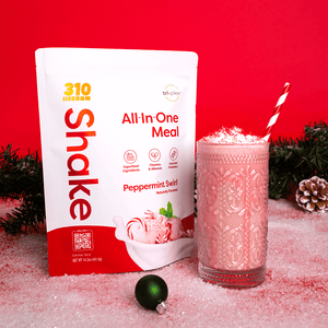 A festive themed 310 peppermint swirl pack with a tall glass of shake.