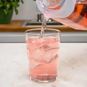 a glass filled with juice from a fruit fuser