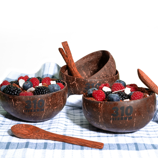 coconut bowl with parfait and spoons on a checkered cloth