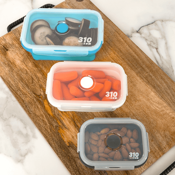 three collapsible containers on a wooden board