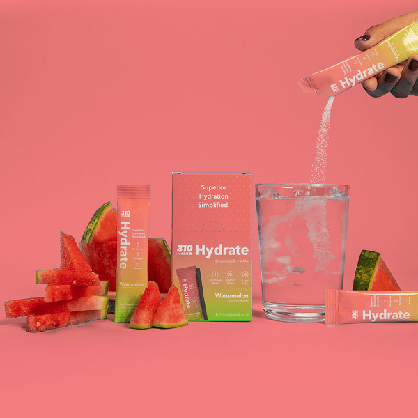 310 hydrate watermelon with a glass of water and fresh sliced watermelon