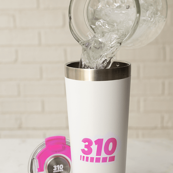 water poured on a pink stainless steel travel mug