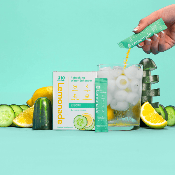 310 cucumber lemonade, fresh lemons, cucumber and a glass of water