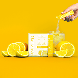 original lemonade water enhancer with fresh lemons on a vibrant yellow background