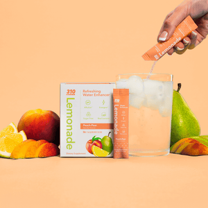 peach-pear lemonade, a glass of water and fresh peach, lemon and pear