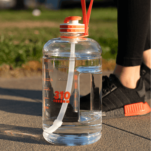 clear mega hydration bottle on the ground