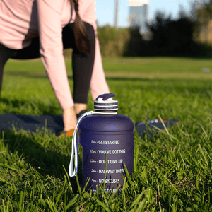 woman on a yoga mat and a mega hydration bottle on the side