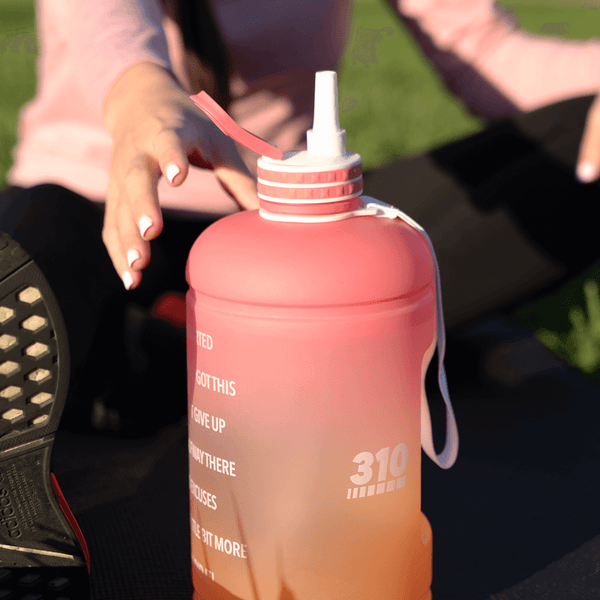 woman reaching the sunset mega hydration bottle