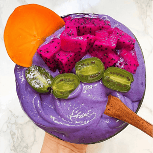purple smoothie bowl with fresh fruits on top